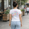 MADRE Spanish mom t-shirt with colorful floral design and motherhood words, Latina mom graphic tee worn with jeans, meaningful mom shirt