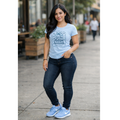 Model wearing light blue autism awareness shirt with bow design front view