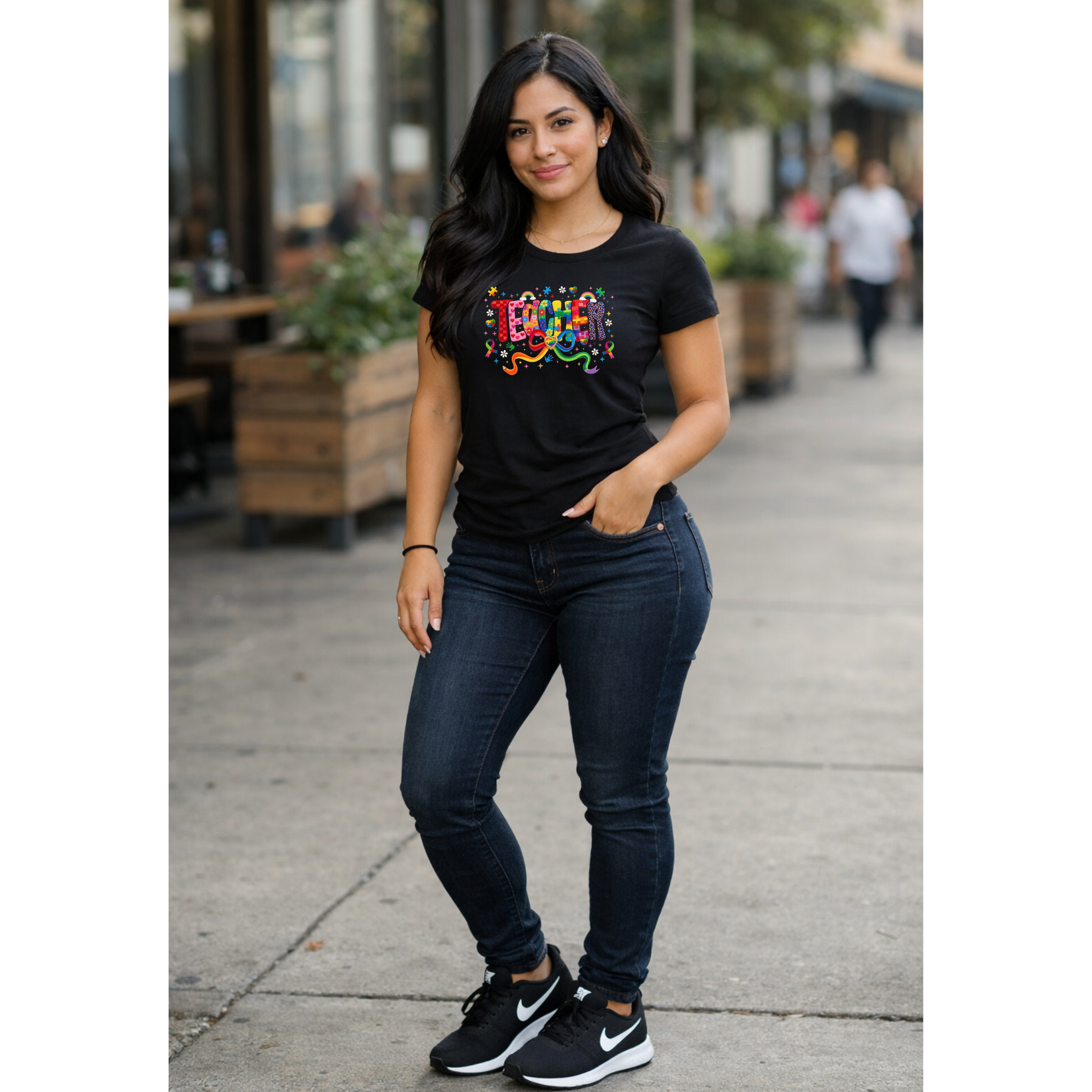 Model wearing black autism awareness shirt with colorful celebrate design