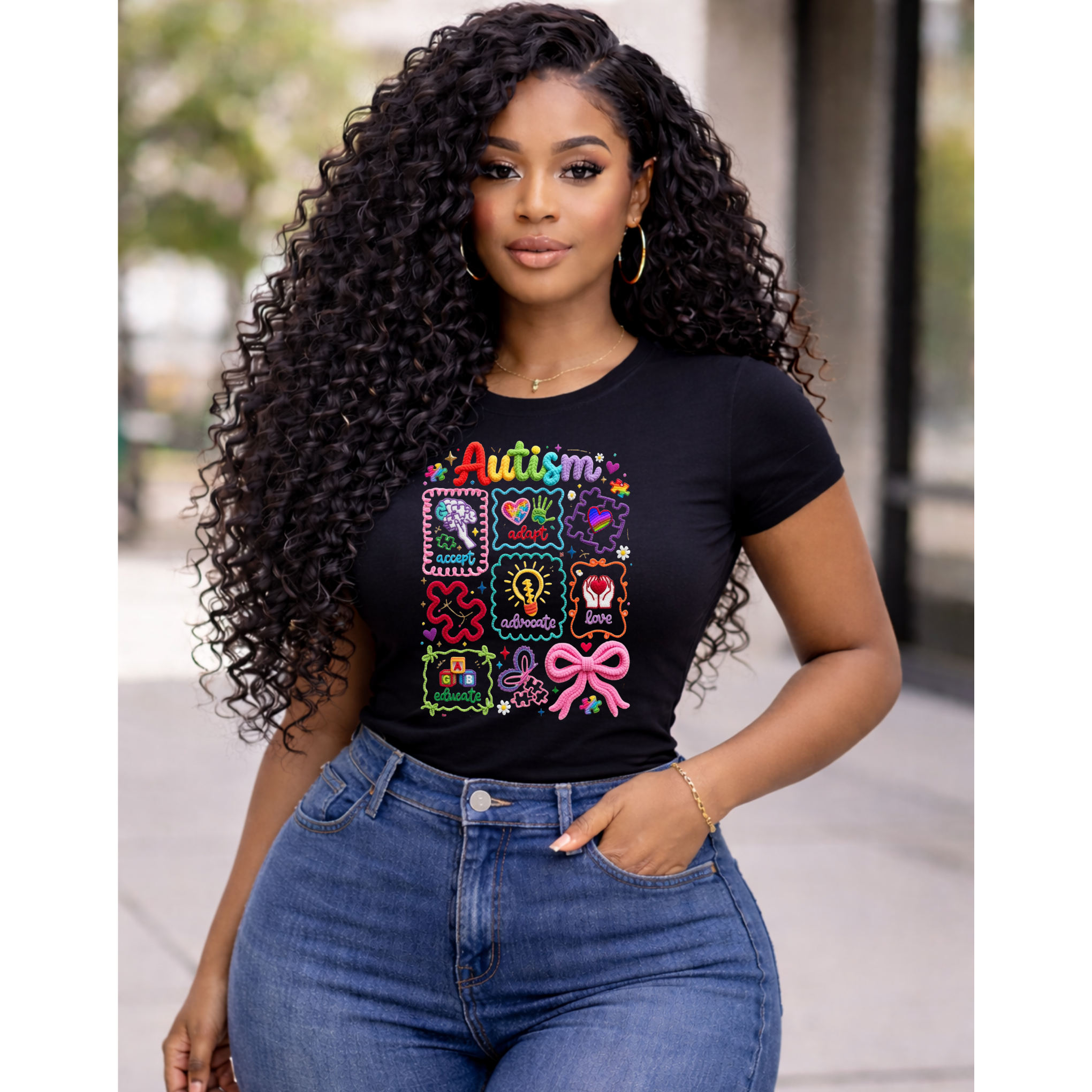 Model wearing black autism awareness shirt with colorful icons design